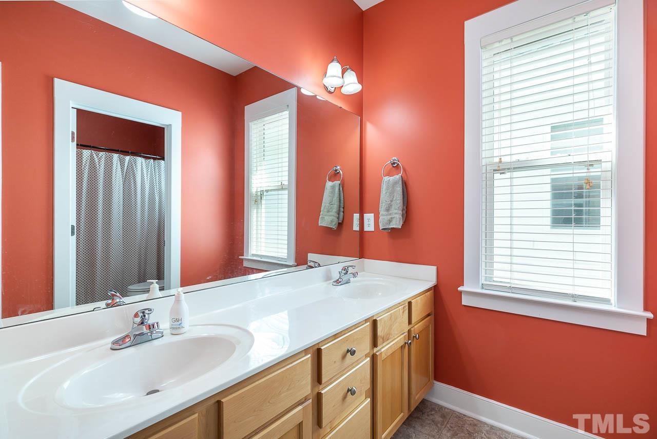 2813 Falls River Avenue Raleigh, NC 27614 - Photo 21 of 28 a bathroom with a sink double vanity and a mirror