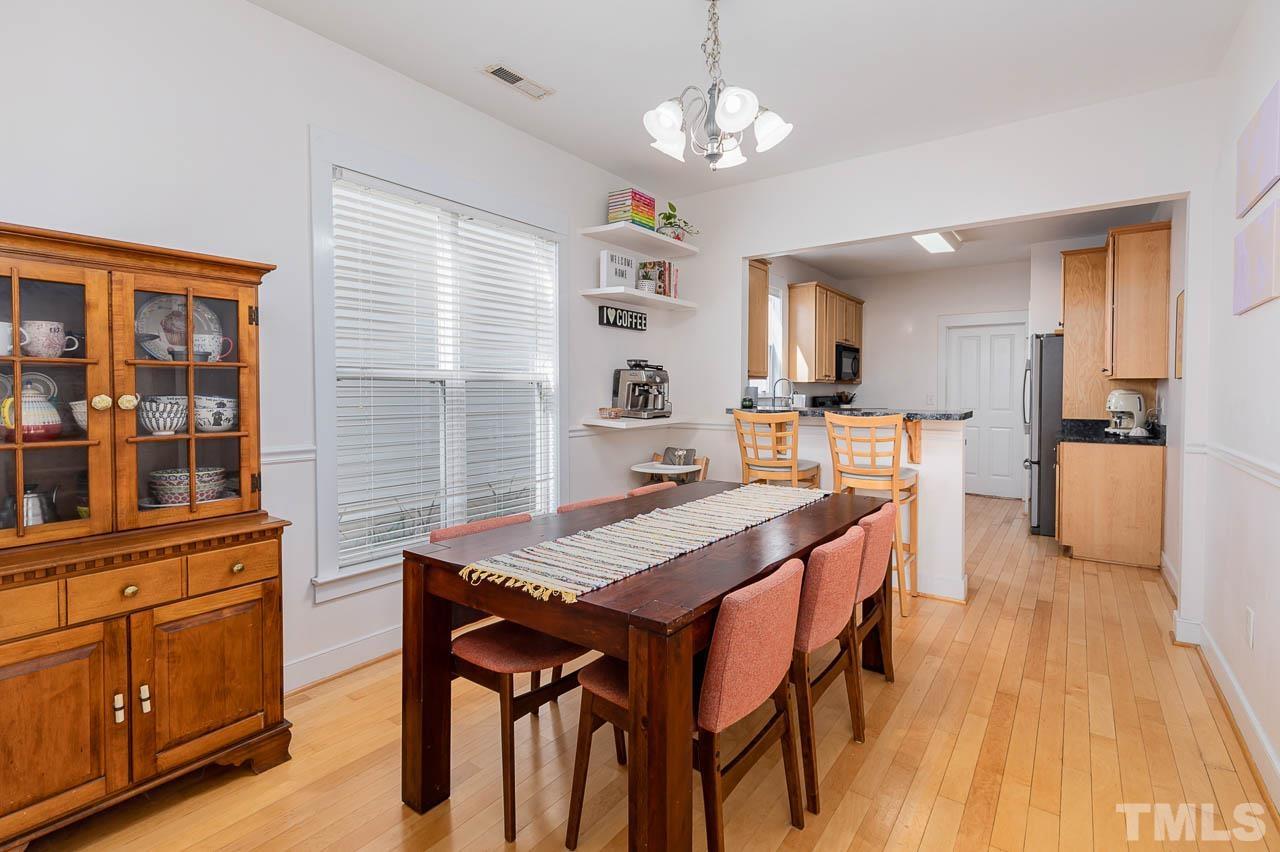 2813 Falls River Avenue Raleigh, NC 27614 - Photo 5 of 28 a view of a dining room with furniture window and wooden floor