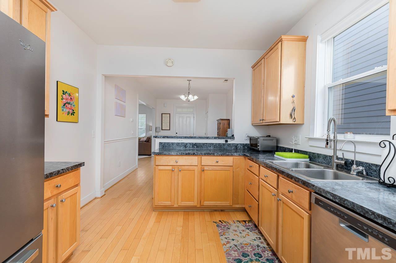 2813 Falls River Avenue Raleigh, NC 27614 - Photo 7 of 28 a kitchen with stainless steel appliances granite countertop a sink a stove top oven a counter space and cabinets