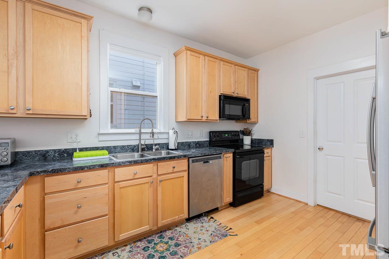 2813 Falls River Avenue Raleigh, NC 27614 - Photo 8 of 28 a kitchen with granite countertop a sink and a stove top oven