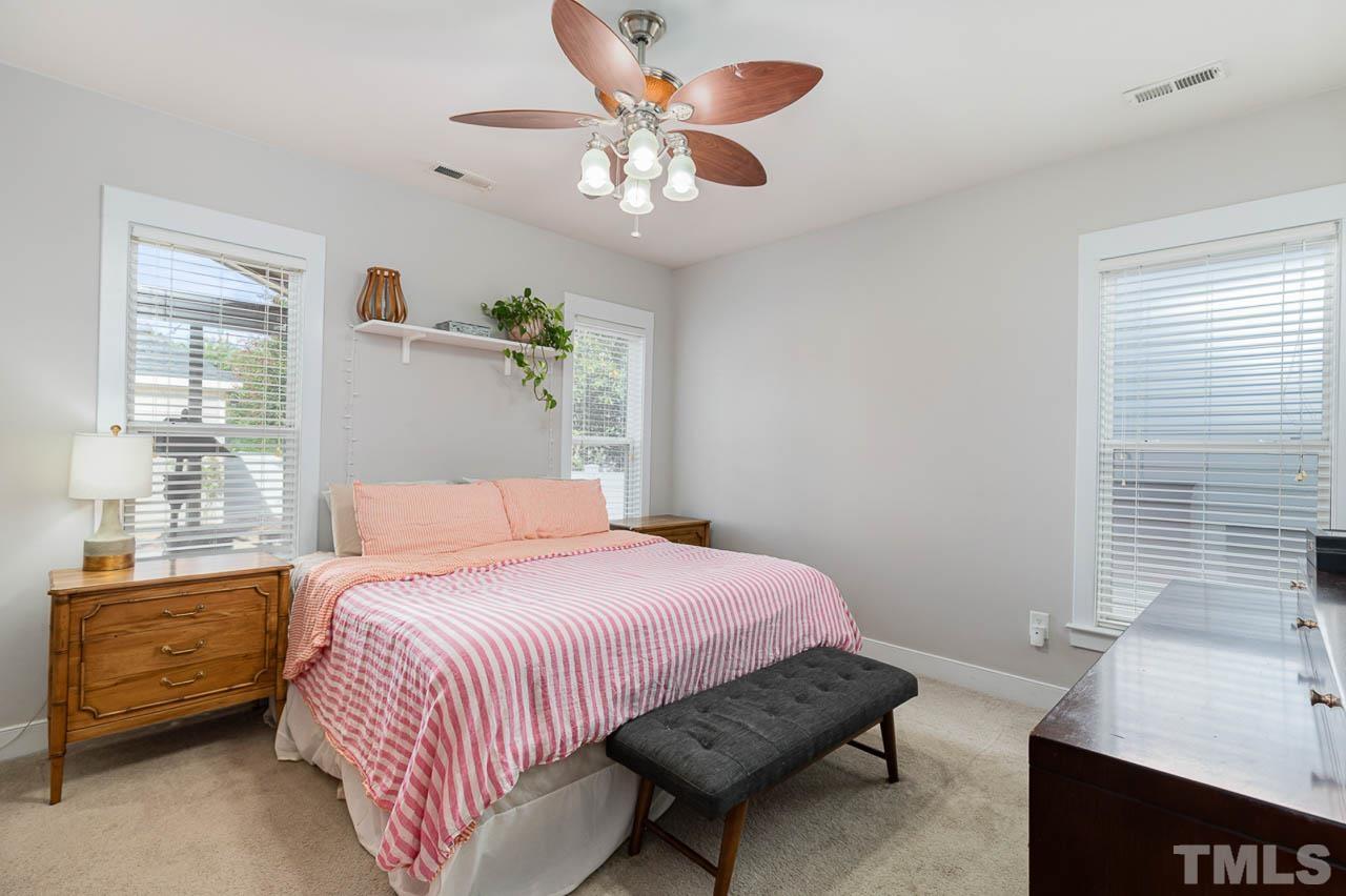 2813 Falls River Avenue Raleigh, NC 27614 - Photo 10 of 28 a bedroom with a bed and a chandelier