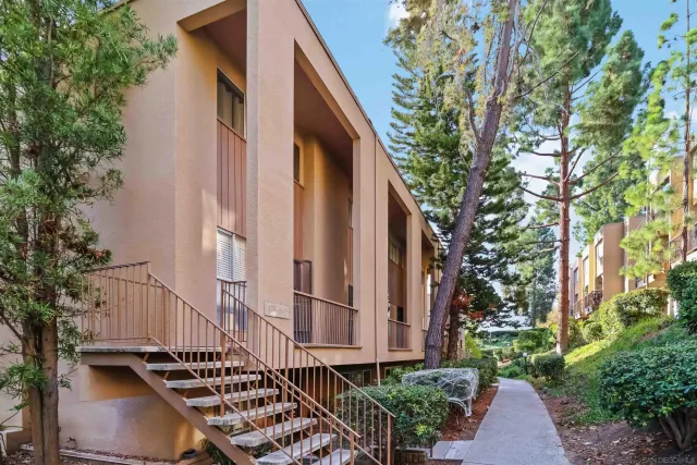 a backyard of a house with plants and outdoor seating