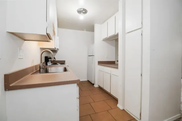 a kitchen with a sink and cabinets