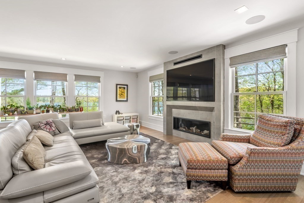 151 Forest Street Sherborn, MA 01770 - Photo 13 of 41 a living room with furniture a flat screen tv and a fireplace