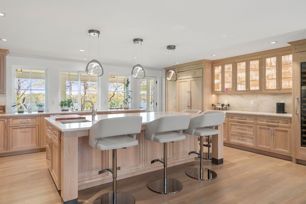 151 Forest Street Sherborn, MA 01770 - Photo 10 of 41 a kitchen with a table chairs sink and cabinets