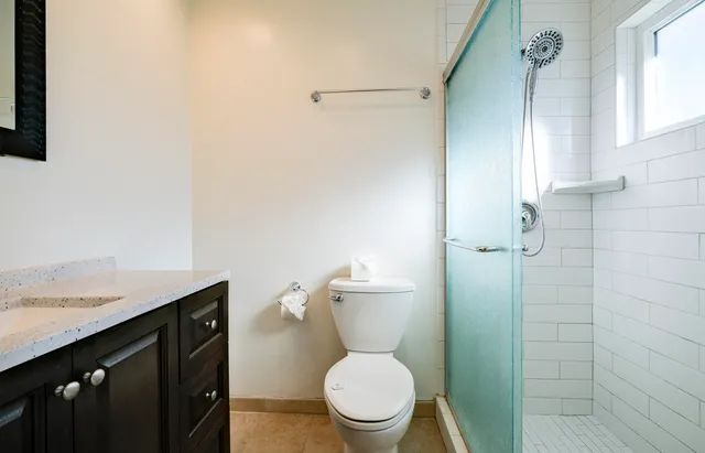 a kitchen with refrigerator and cabinets