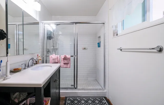 a kitchen with a refrigerator and a stove top oven