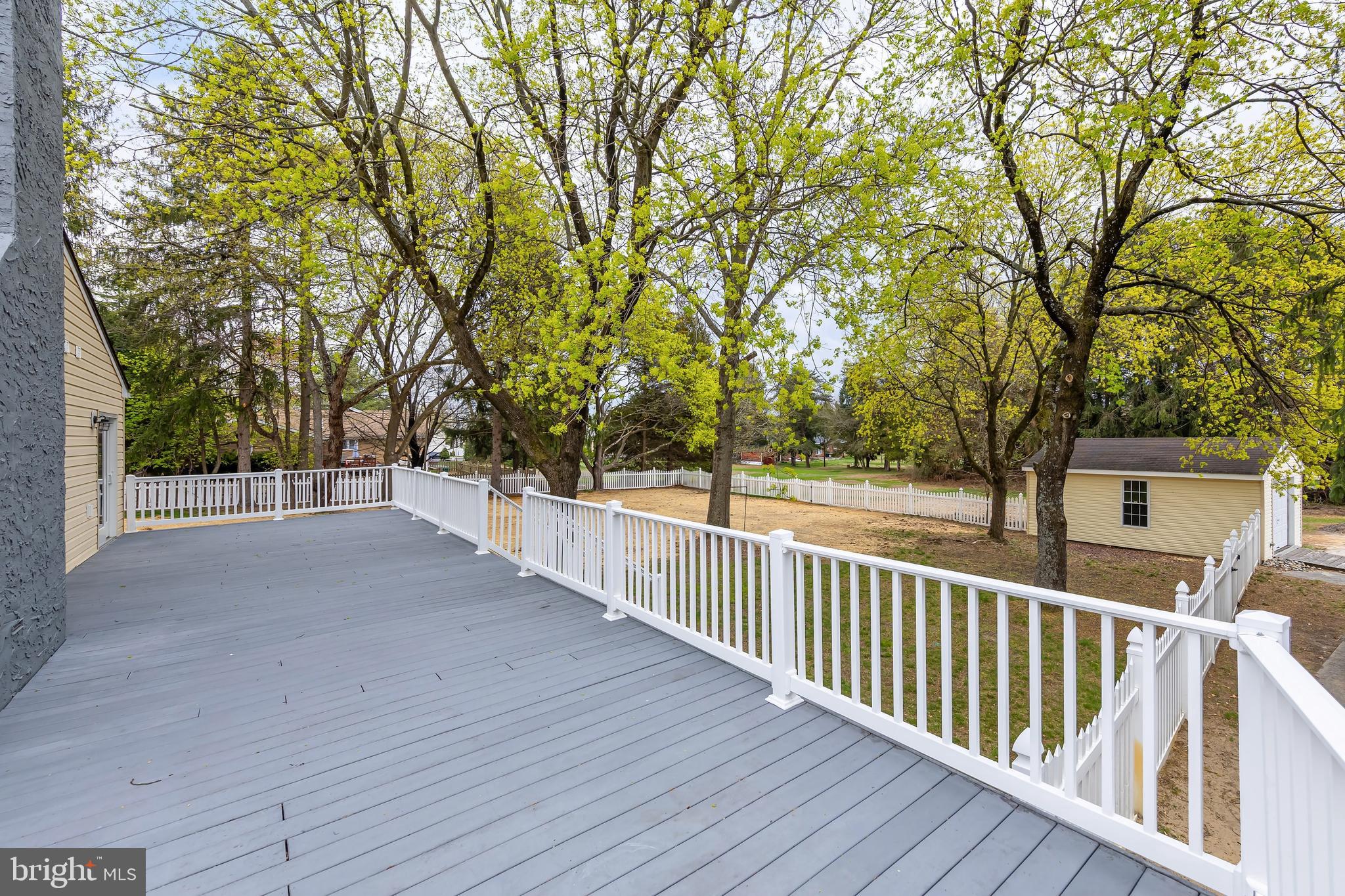 370 Ganttown Road Sewell, NJ 08080 - Photo 16 of 46 a view of a deck with large trees and wooden fence