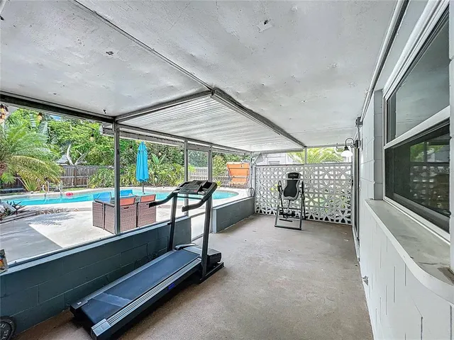 an aerial view of residential houses with outdoor space and trees
