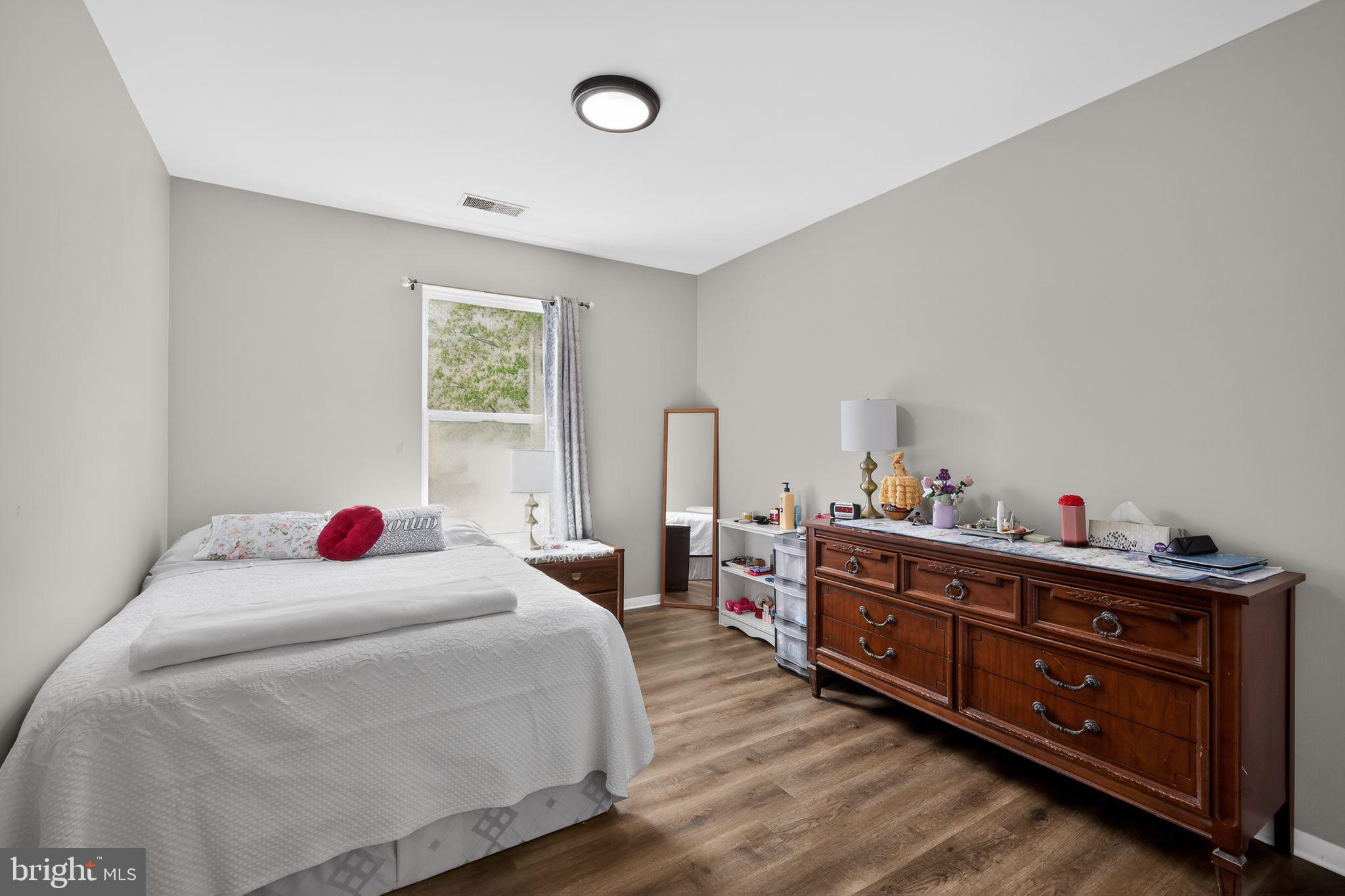 7804 Guildberry Court, Unit 202 Gaithersburg, MD 20879 - Photo 11 of 19 a bedroom with a bed and a dresser