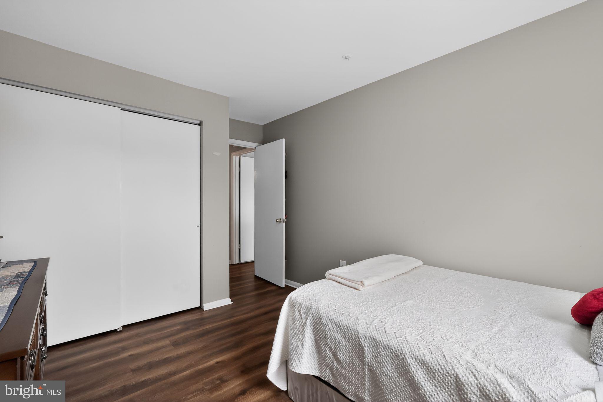 7804 Guildberry Court, Unit 202 Gaithersburg, MD 20879 - Photo 12 of 19 a bedroom with a bed and wooden floor