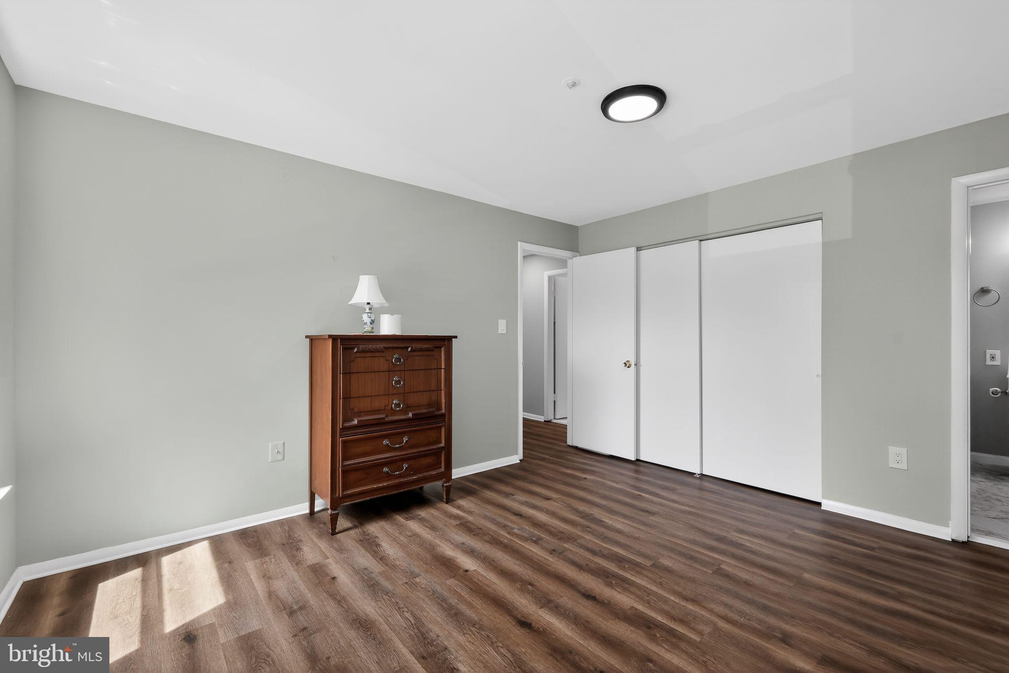 7804 Guildberry Court, Unit 202 Gaithersburg, MD 20879 - Photo 15 of 19 a view of an empty room with wooden floor and window