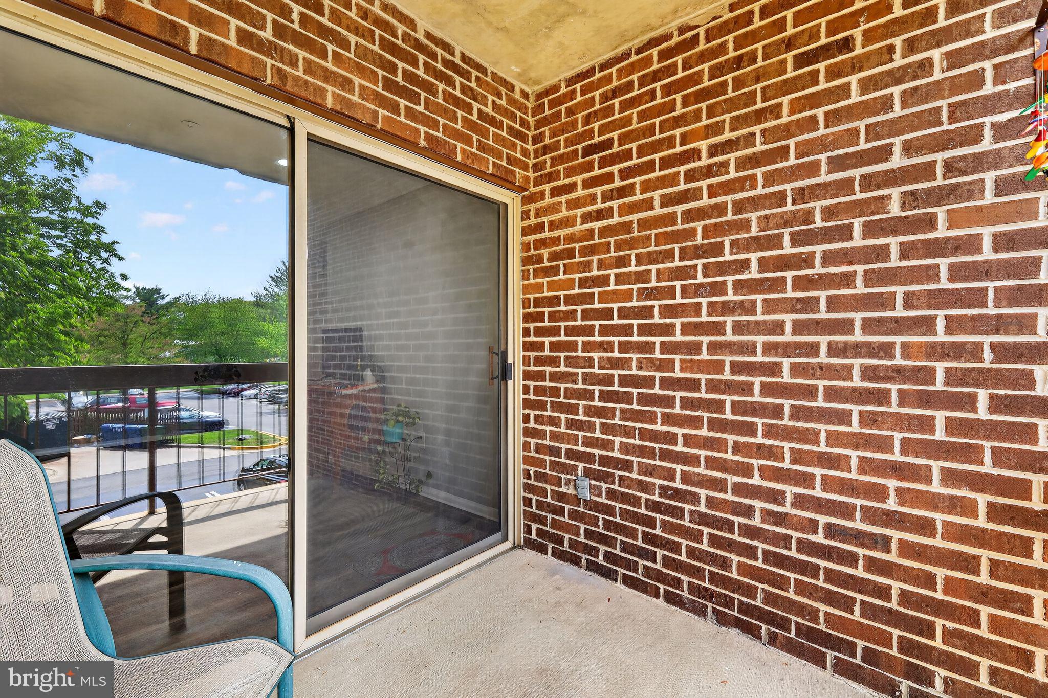 7804 Guildberry Court, Unit 202 Gaithersburg, MD 20879 - Photo 18 of 19 a view of a brick wall with a balcony