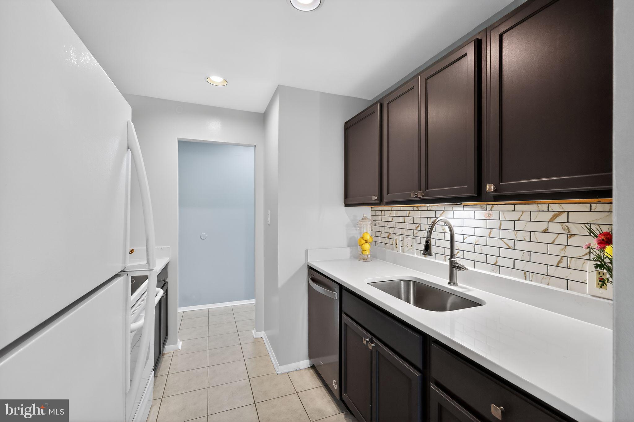 7804 Guildberry Court, Unit 202 Gaithersburg, MD 20879 - Photo 3 of 19 a kitchen with a sink and cabinets