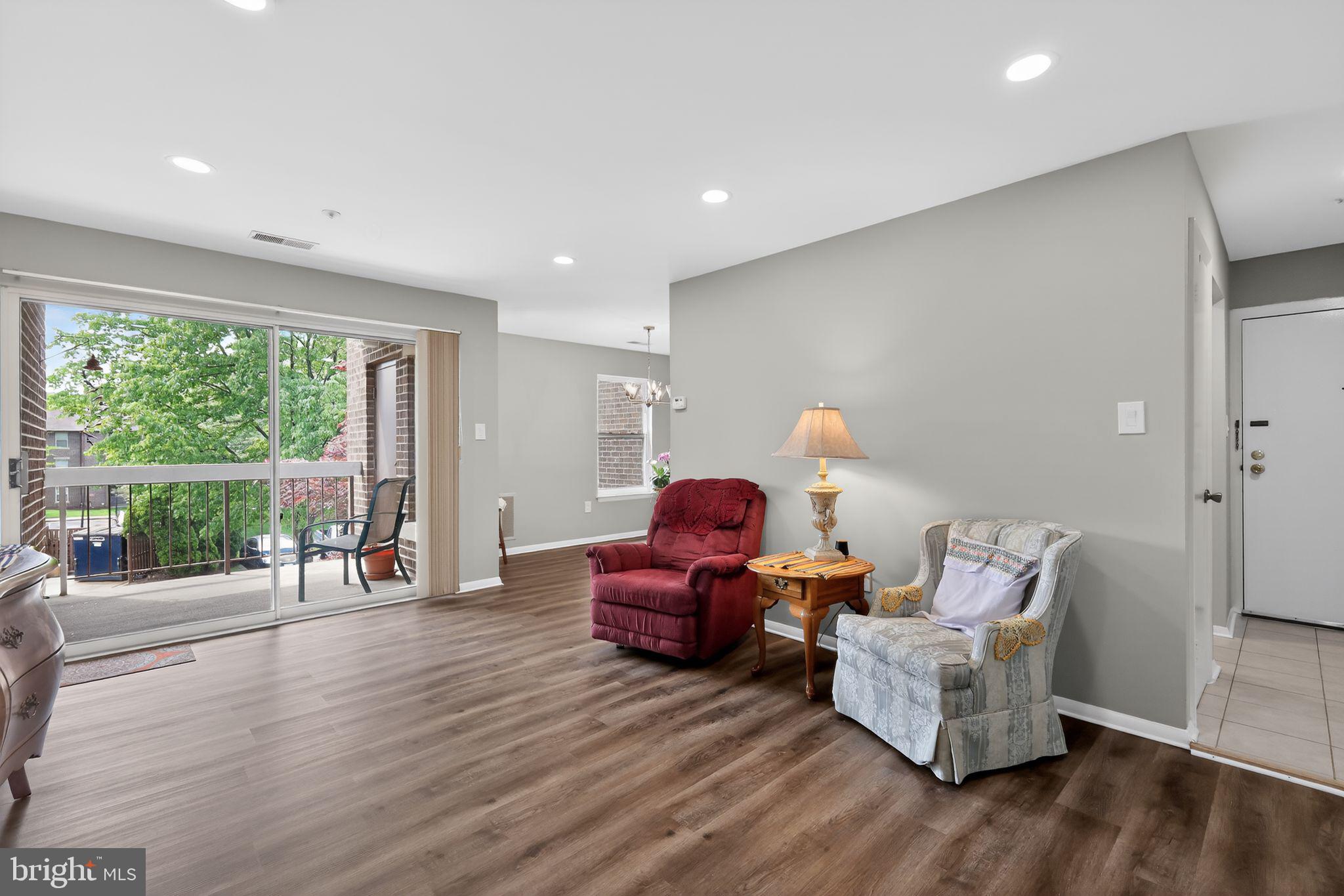7804 Guildberry Court, Unit 202 Gaithersburg, MD 20879 - Photo 4 of 19 a living room with furniture and wooden floor