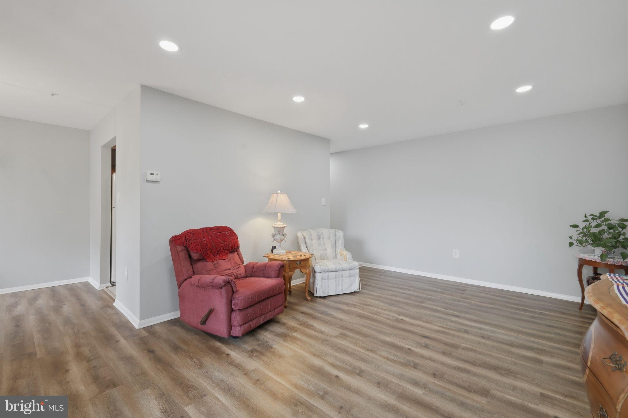 7804 Guildberry Court, Unit 202 Gaithersburg, MD 20879 - Photo 10 of 19 a living room with furniture and wooden floor