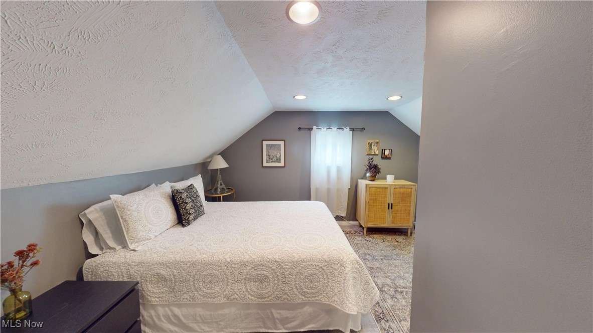 2412 Charney Road Cleveland, OH 44118 - Photo 31 of 48 Carpeted bedroom with a textured ceiling and lofted ceiling