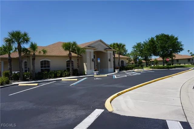 a view of swimming pool with a bench in front of building