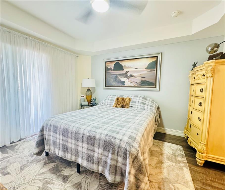 Bedroom with dark wood-type flooring and ceiling fan