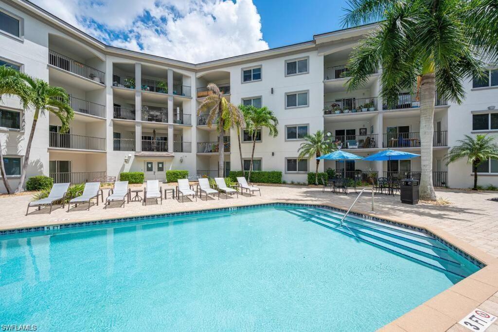 1100 Pine Ridge Road, Unit 401B Naples, FL 34108 - Photo 10 of 11 View of pool featuring a patio