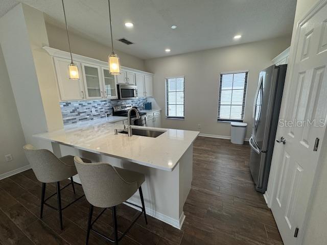 906 Pawstand Road Celebration, FL 34747 - Photo 11 of 29 a kitchen with sink cabinets and wooden floor