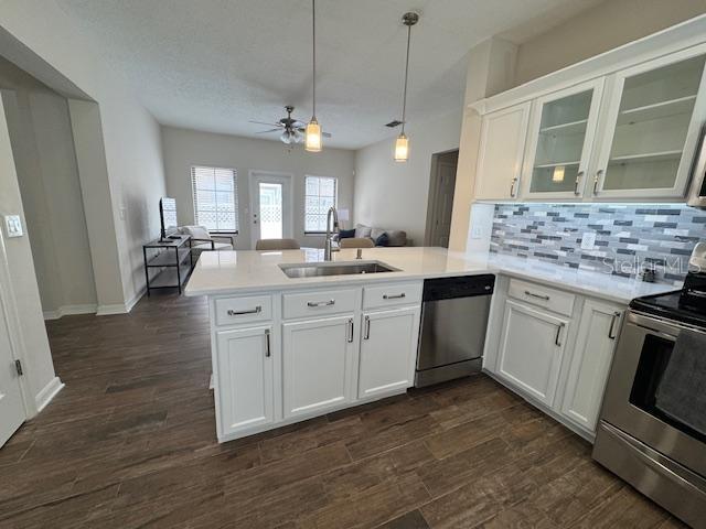 906 Pawstand Road Celebration, FL 34747 - Photo 14 of 29 a kitchen with a sink stove and wooden floor
