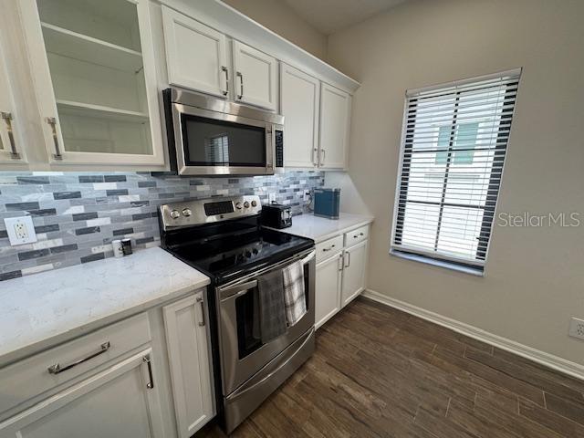 906 Pawstand Road Celebration, FL 34747 - Photo 15 of 29 a kitchen with stainless steel appliances a stove a microwave and sink