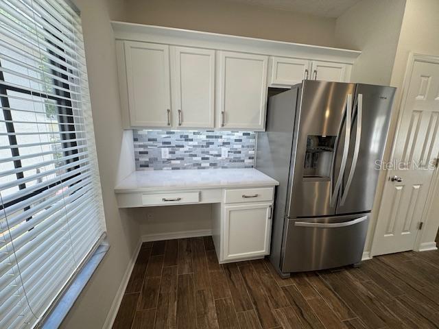 906 Pawstand Road Celebration, FL 34747 - Photo 16 of 29 a kitchen with kitchen island white cabinets and stainless steel appliances