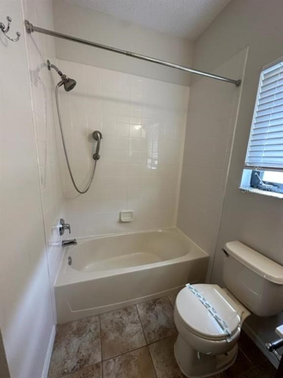 906 Pawstand Road Celebration, FL 34747 - Photo 22 of 29 a bathroom with a toilet and a bathtub