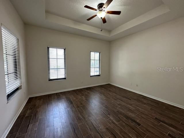 906 Pawstand Road Celebration, FL 34747 - Photo 5 of 29 a view of an empty room with wooden floor and a window