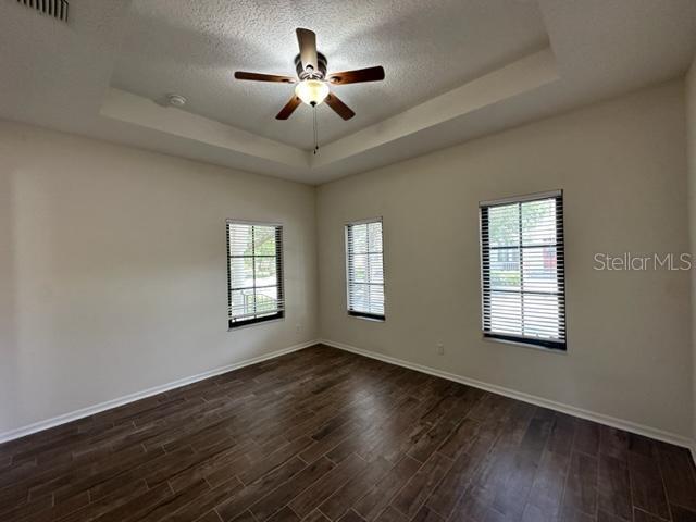 906 Pawstand Road Celebration, FL 34747 - Photo 6 of 29 a view of an empty room with a window and wooden floor