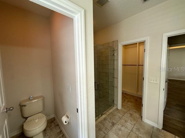 906 Pawstand Road Celebration, FL 34747 - Photo 9 of 29 a bathroom with a toilet and a shower