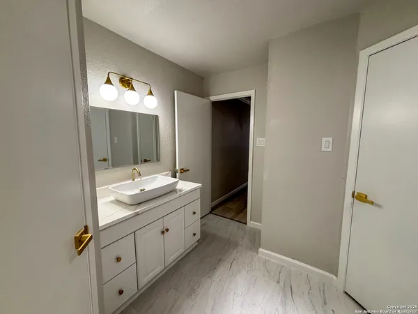 a bathroom with a double vanity sink and mirror