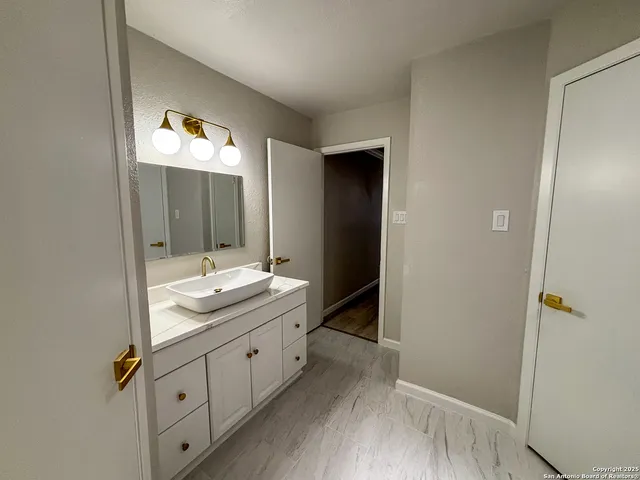 a bathroom with a double vanity sink and mirror