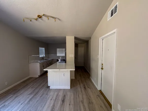a room with a wooden floor and a sink