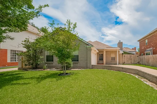 a front view of house with a garden and patio