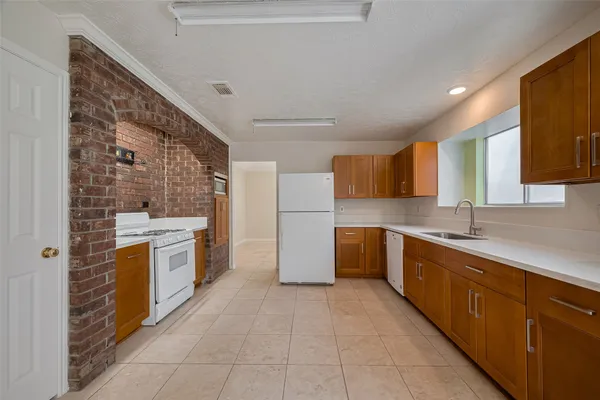 a large kitchen with a stove and a refrigerator