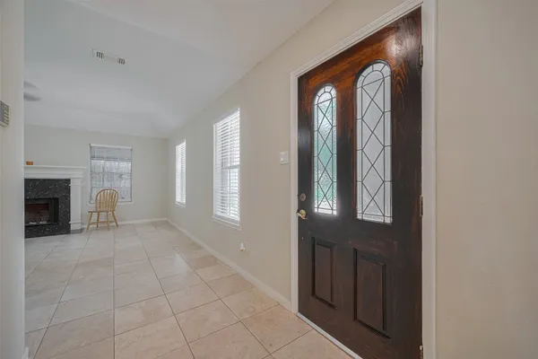 a view of a livingroom with a fireplace and window