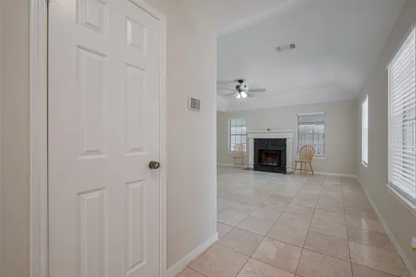 an empty room with fireplace and windows