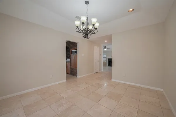 a view of an empty room with a chandelier