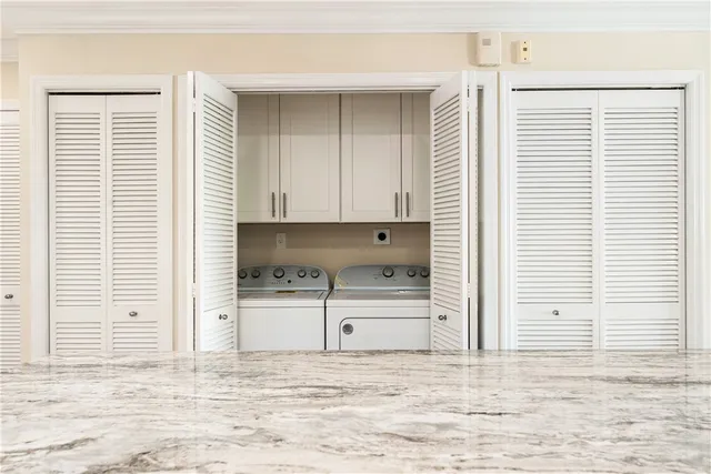 a kitchen with stainless steel appliances kitchen island granite countertop a stove a refrigerator and a dining table with wooden floor