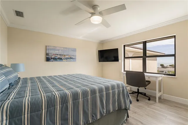 a bedroom with a large bed and a chandelier