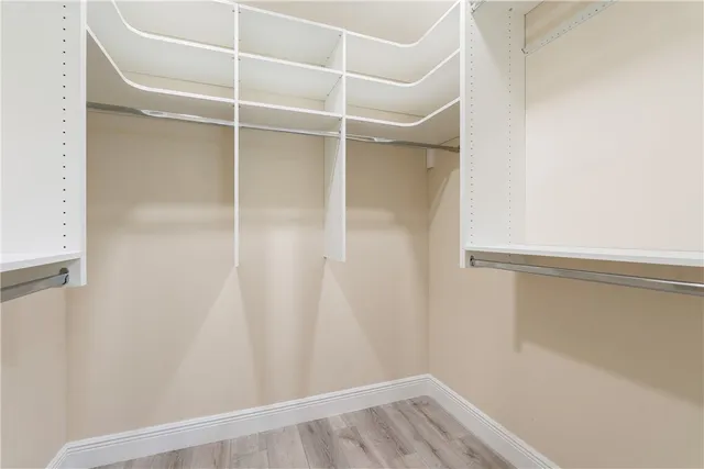 a spacious bathroom with a granite countertop sink toilet a large mirror a vanity and