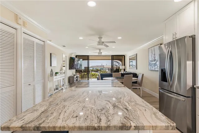 a kitchen with kitchen island granite countertop stainless steel appliances and a counter space