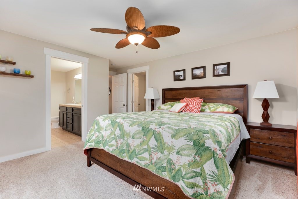 2329 Cedar Road Lake Stevens, WA 98258 - Photo 14 of 40 a bedroom with a bed and a chandelier