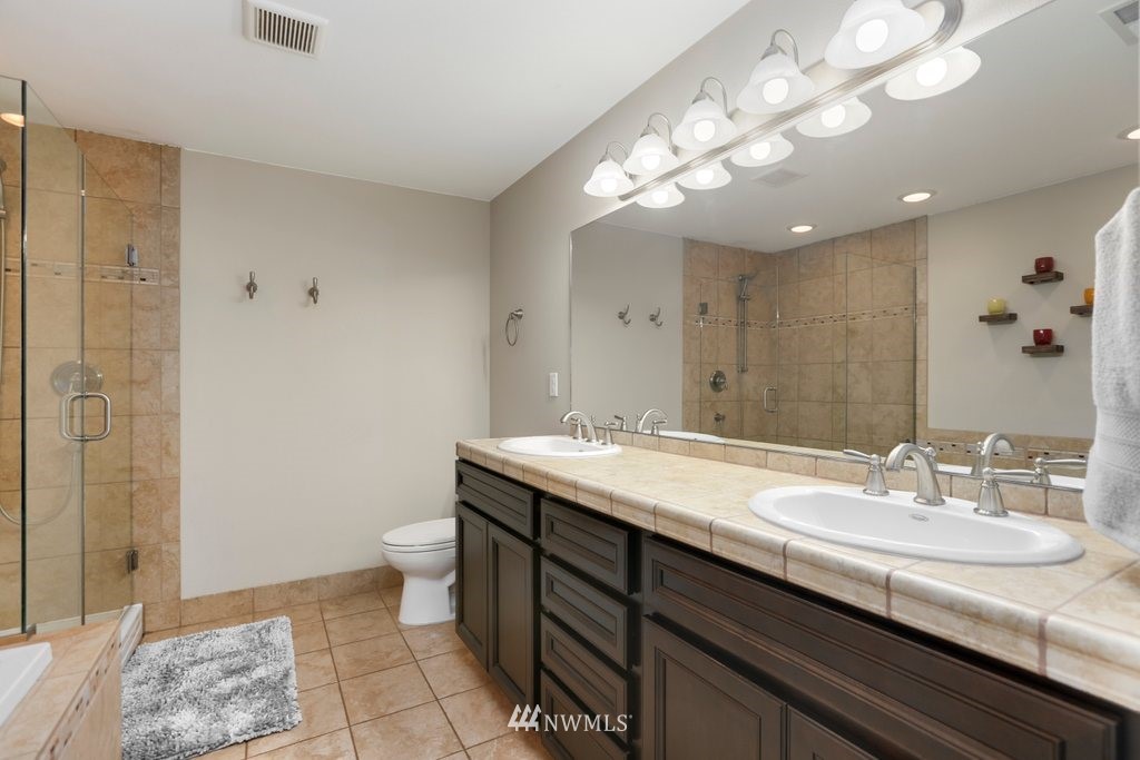 2329 Cedar Road Lake Stevens, WA 98258 - Photo 16 of 40 a bathroom with a sink a toilet and a mirror