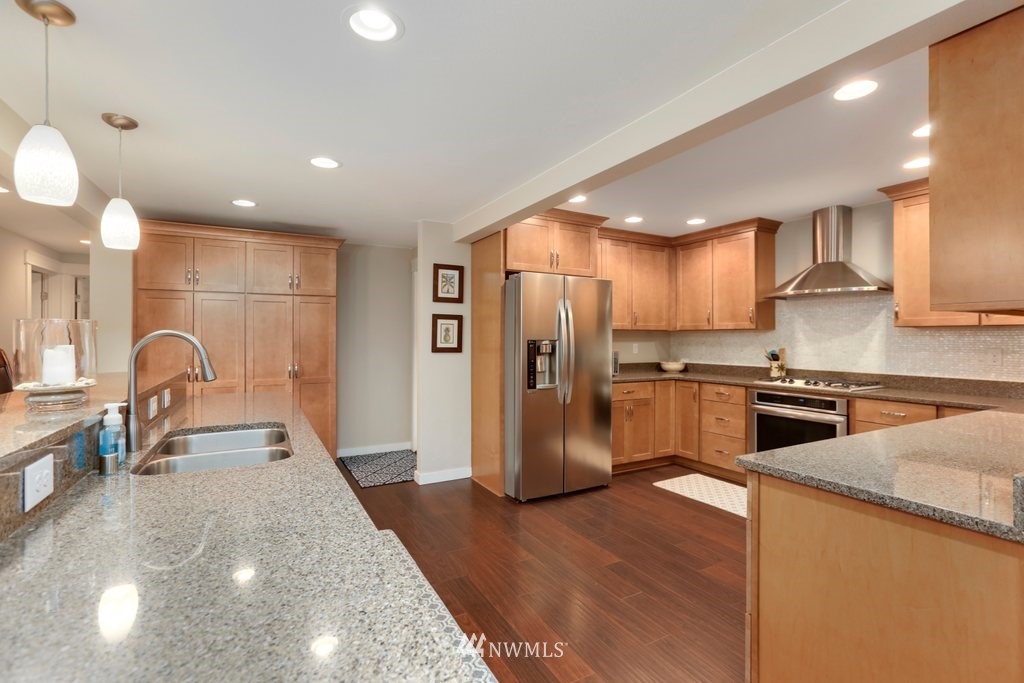 2329 Cedar Road Lake Stevens, WA 98258 - Photo 7 of 40 a kitchen with stainless steel appliances kitchen island granite countertop a stove a sink a refrigerator and cabinets