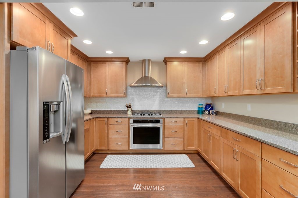 2329 Cedar Road Lake Stevens, WA 98258 - Photo 8 of 40 a kitchen with stainless steel appliances granite countertop a stove a refrigerator and a sink