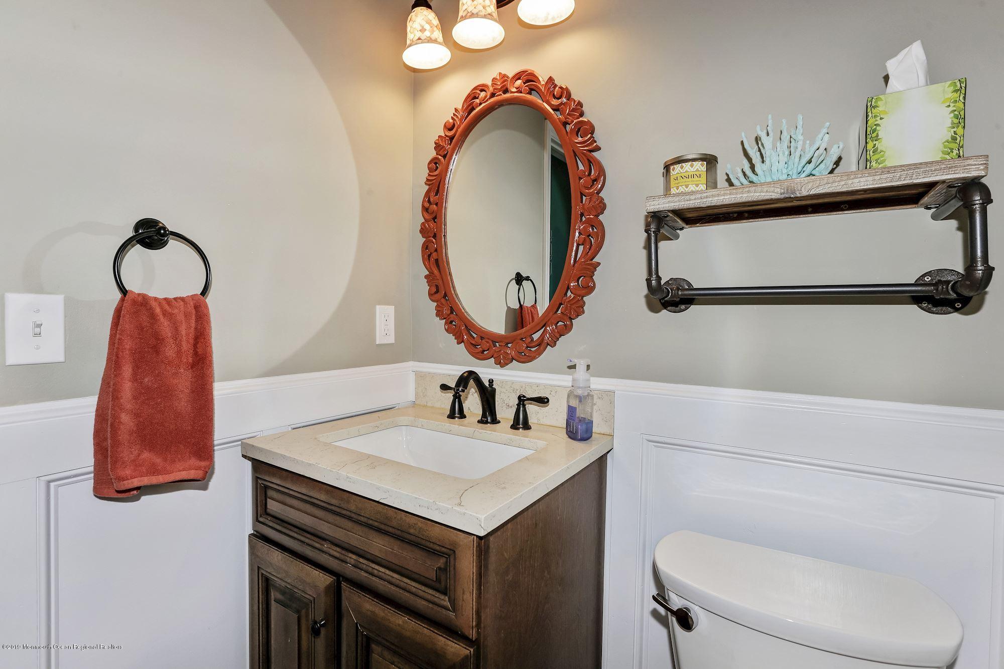 409 Raleigh Road Brick, NJ 08723 - Photo 22 of 33 a bathroom with a sink mirror and toilet