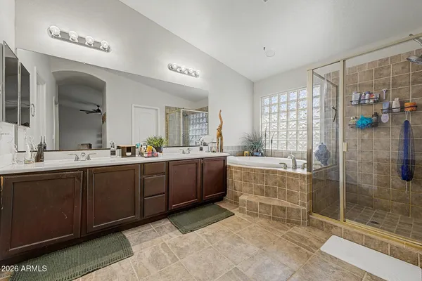 a spacious bathroom with a shower sink and mirror